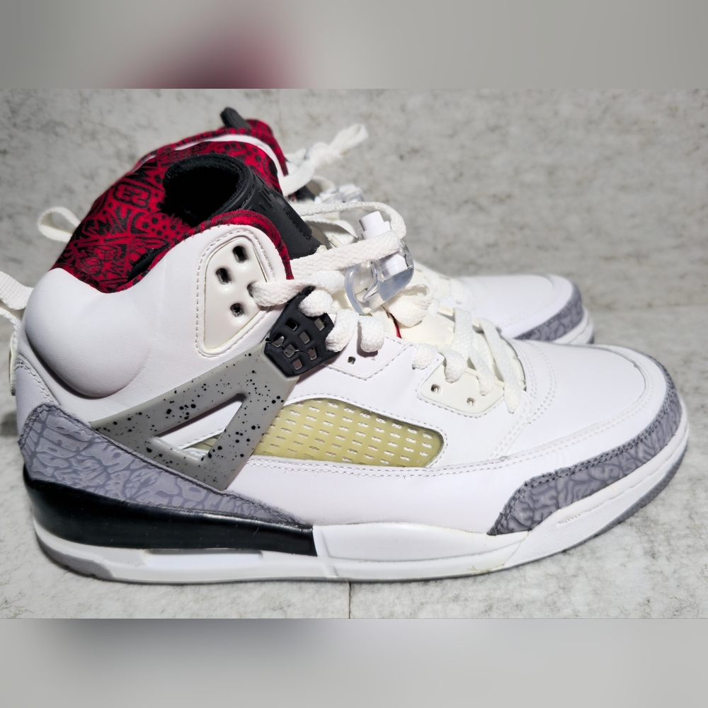 This is a pair of Jordan Spizike "White Cement" sneakers. 